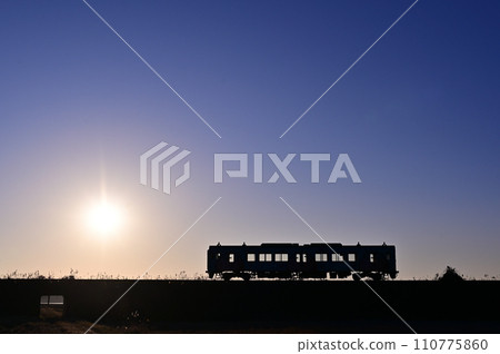 Kashima Rinkai Railway's 8000-series diesel train illuminated by the setting sun Kashima Rinkai Railway's 8000-series diesel train illuminated by the setting sun 110775860