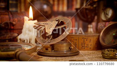 Vintage style travel and adventure. Vintage old compass and other vintage items on the table. Vintage style travel and adventure. Vintage old compass and other vintage items on the table. 110776680