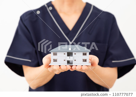Medical workers, nurses, doctors, care workers with house models 110777077