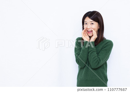 A woman in her 40s whispering 110777687