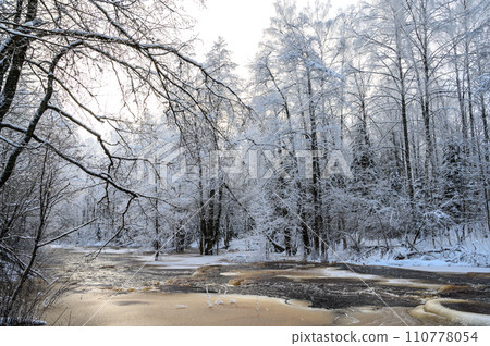 winter river in snowfall. beautiful snowy tree branches 110778054