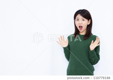 Surprised woman in her 40s 110778186