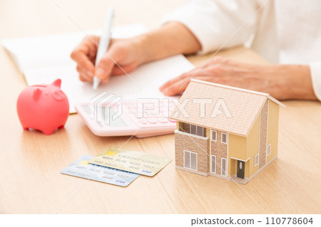 A middle-aged woman keeping a household account book A middle-aged woman keeping a household account book 110778604