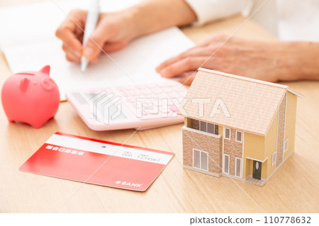 A middle-aged woman keeping a household account book 110778632