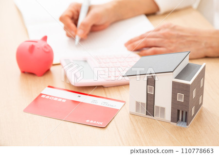 A middle-aged woman keeping a household account book 110778663