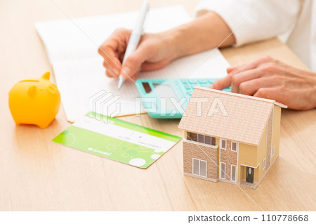 A middle-aged woman keeping a household account book 110778668