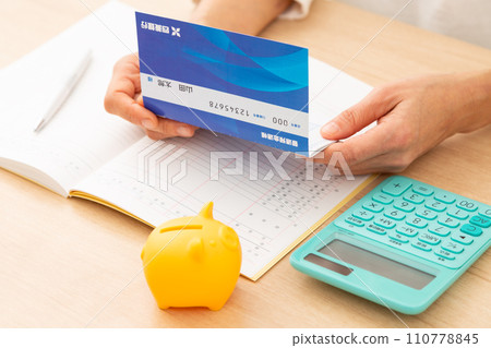 A middle-aged woman keeping a household account book 110778845