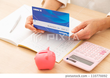 A middle-aged woman keeping a household account book 110778892