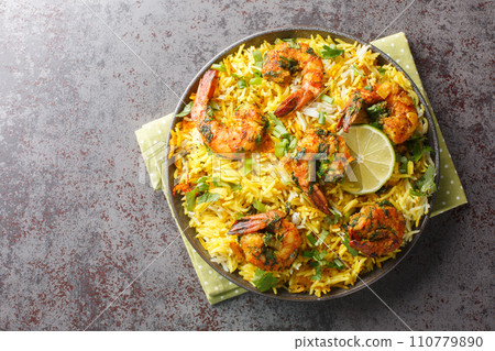 Popular Iranian seafood pilaf Meygoo Polo with herbs and prawns closeup on the plate. Horizontal top view Popular Iranian seafood pilaf Meygoo Polo with herbs and prawns closeup on the plate. Horizontal top view 110779890