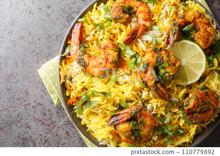 Persian Shrimp Rice Meygoo Polo with herbs and lime closeup on the plate. Horizontal top view Persian Shrimp Rice Meygoo Polo with herbs and lime closeup on the plate. Horizontal top view 110779892