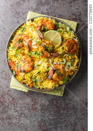 Meygoo Polo pilaf Rice with herbs and prawns closeup on the plate. Vertical top view Meygoo Polo pilaf Rice with herbs and prawns closeup on the plate. Vertical top view 110779893