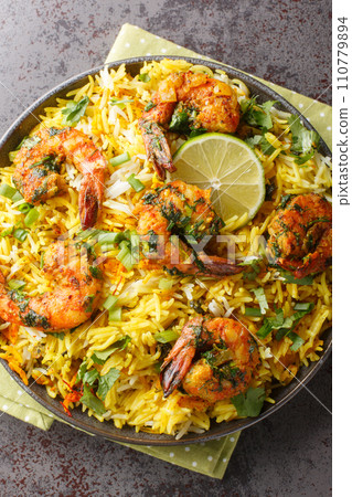 Persian style shrimp rice with lots of herbs and spices closeup on the plate. Vertical top view Persian style shrimp rice with lots of herbs and spices closeup on the plate. Vertical top view 110779894