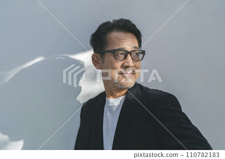 A man in his mid-50s wearing glasses 110782183