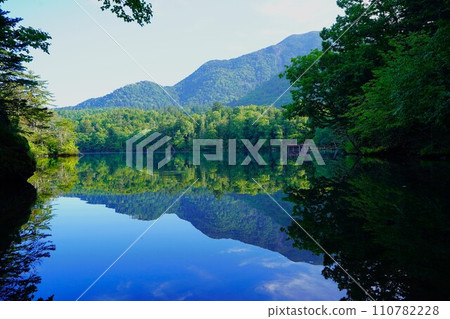 The foot of Mt. Oakandake reflected on the surface of Lake Akan The foot of Mt. Oakandake reflected on the surface of Lake Akan 110782228