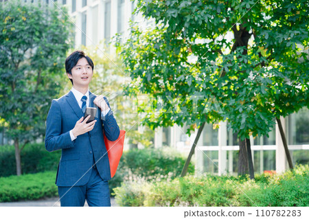 Businessman commuting in a suit Businessman commuting in a suit 110782283