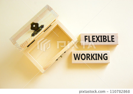 Flexible working symbol. Concept words Flexible working on beautiful wooden blocks. Beautiful white table white background. Empty wooden chest. Business flexible working concept. Copy space. 110782868