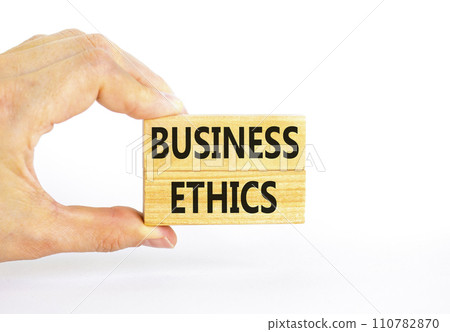 Business ethics symbol. Concept words Business ethics on beautiful wooden blocks. Beautiful white table white background. Businessman hand. Business ethics concept. Copy space. Business ethics symbol. Concept words Business ethics on beautiful wooden blocks. Beautiful white table white background. Businessman hand. Business ethics concept. Copy space. 110782870