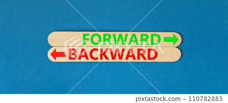 Forward or backward symbol. Concept word Forward or Backward on beautiful wooden stick. Beautiful blue table blue background. Business forward or backward concept. Copy space. 110782883