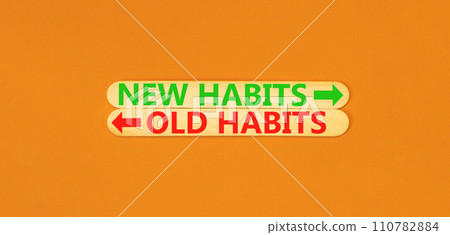 New or old habits symbol. Concept word New habits Old habits on beautiful wooden stick. Beautiful orange table orange background. Business new or old habits concept. Copy space. 110782884