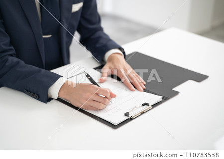 Hand of a businessman signing a childcare leave application form 110783538