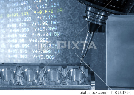 The abstract scene the 5-axis machining center cutting the V8 engine cylinder block and NC data background. 110783794