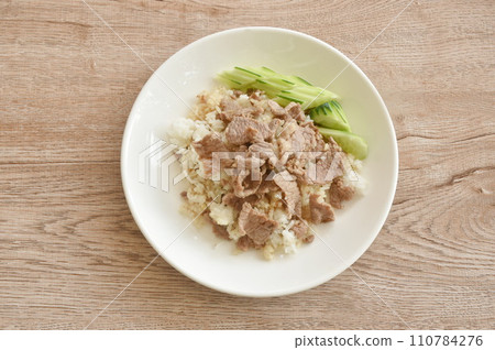 fried salty slice beef meat with garlic and pepper on rice in plate fried salty slice beef meat with garlic and pepper on rice in plate 110784276