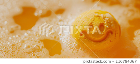 Orange bath bomb in water with happy smile Orange bath bomb in water with happy smile 110784367