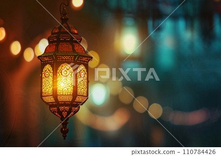 Ornamental Arabic lantern with burning candle in the evening Ornamental Arabic lantern with burning candle in the evening 110784426