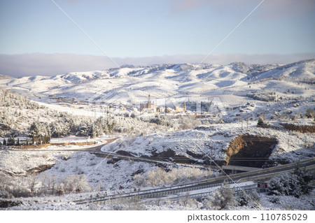 Snow. Winter landscape covered in a white blanket of snow covering mountains and roads. Trees with snow. Clear day. White blanket due to a storm with heavy snowfall. In Spain. January. 2024. Snow. Winter landscape covered in a white blanket of snow covering mountains and roads. Trees with snow. Clear day. White blanket due to a storm with heavy snowfall. In Spain. January. 2024. 110785029