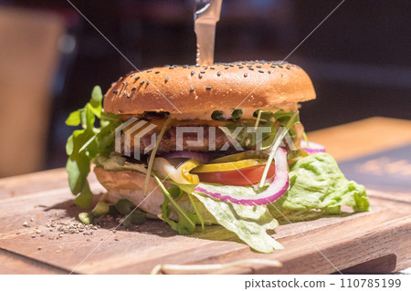 Juicy American cheeseburger on a wooden board. Juicy American cheeseburger on a wooden board. 110785199