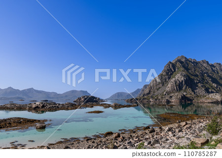 Crystal-clear waters and rugged peaks of Lofoten Islands in a serene landscape 110785287