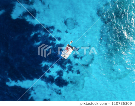 Drone view of a sailing yacht. Luxury transportation. Vacation and holidays. Drone view of a sailing yacht. Luxury transportation. Vacation and holidays. 110786309