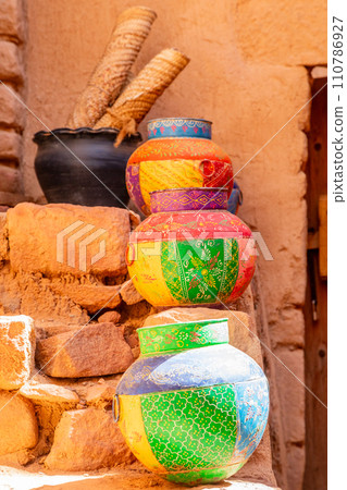 Three ornated traditional decorated arabic jars on street of Al Ula, Medina province, Saudi Arabia Three ornated traditional decorated arabic jars on street of Al Ula, Medina province, Saudi Arabia 110786927