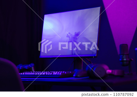 Professional and colorful e-sport gamer room with first-person shooter online video game on computer monitor 110787092