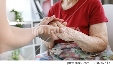 Nurse Soothes Elderly Woman's Hands Nurse Soothes Elderly Woman's Hands 110787313