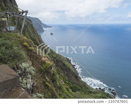 View of cliffs from Miradouro do teleferico, viewpoint at start of the Vereda do Larano hiking trail, from Machico, Madeira island, Portugal, Europe. 110787601
