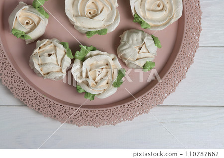 Homemade zephyr spread out on a tray. Flowers from zephyr. Claose-up. Homemade zephyr spread out on a tray. Flowers from zephyr. Claose-up. 110787662