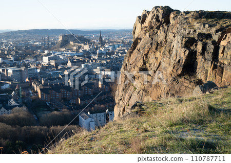 High angle view of the City of Edinburgh against skyline from cliffs of Salisbury Crags near Arthur's Seat. 110787711