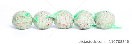 Fat balls for feeding wild garden birds, suet, in nets, isolated on white background 110788846
