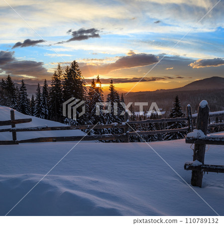 Small and quiet alpine village outskirts and winter sunrise snowy mountains around, Voronenko, Carpathian, Ukraine. 110789132