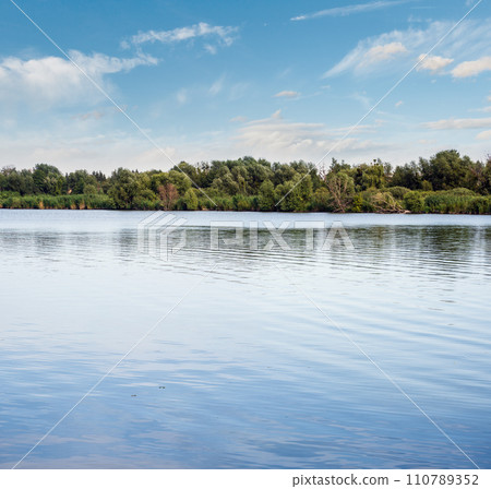 Summer hazy day on picturesque lake 110789352