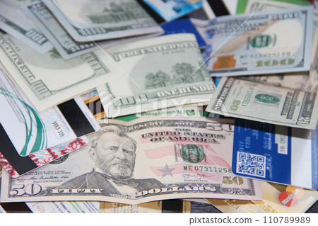 Banknotes with credit cards. Cash and non-cash money. Heap of credit cards. Banknotes with credit cards. Cash and non-cash money. Heap of credit cards. 110789989