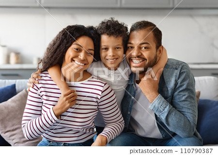Happy Family Portrait. Smiling black parents and their little son posing together 110790387