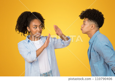 A teenage girl with a defensive hand gesture seems to be cautiously negotiating personal space 110790406