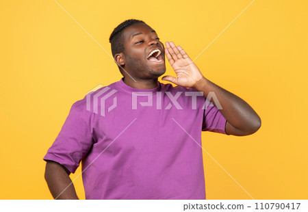 Black Guy Shouting Looking Aside Holding Hand Near Mouth, Studio 110790417