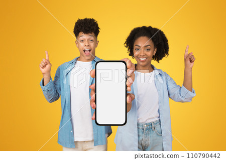 Excited young woman and man presenting a blank smartphone screen with room for text Excited young woman and man presenting a blank smartphone screen with room for text 110790442