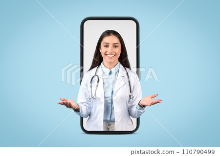 Friendly european female doctor with stethoscope emerges from smartphone screen, engaging with welcoming gesture Friendly european female doctor with stethoscope emerges from smartphone screen, engaging with welcoming gesture 110790499