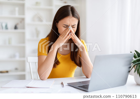 Overworking Concept. Tired Asian Woman Suffering Headache After Working On Laptop Overworking Concept. Tired Asian Woman Suffering Headache After Working On Laptop 110790613