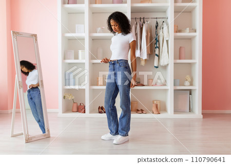 Sad latin woman fitting new jeans 110790641