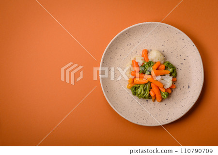Delicious fresh vegetables broccoli, cauliflower, carrots steamed with salt and spices Delicious fresh vegetables broccoli, cauliflower, carrots steamed with salt and spices 110790709